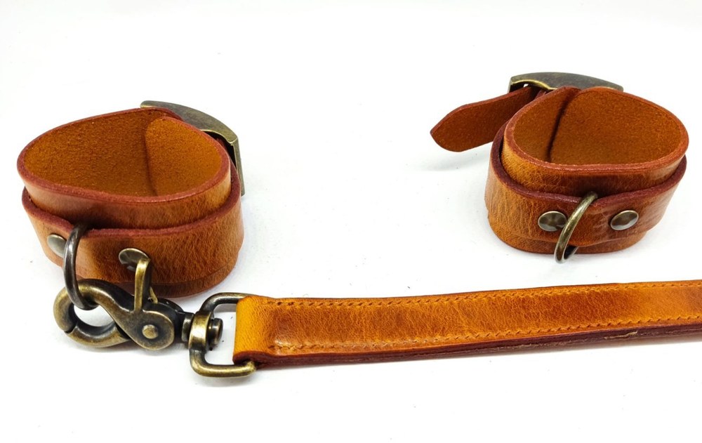 Pair of BDSM handcuffs in cognac leather, handmade by Caresse de Cuir
